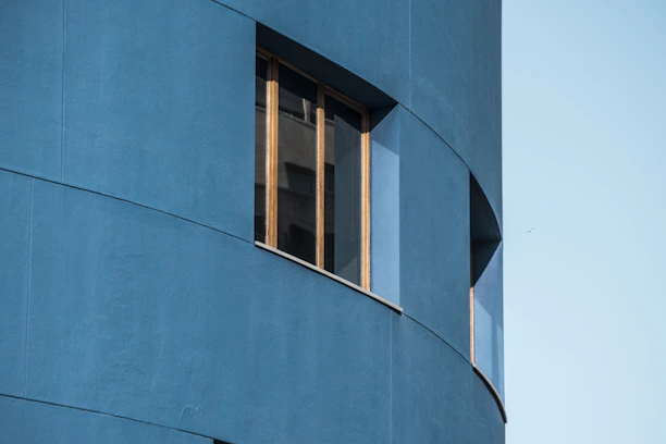 Close-up of a modern exterior wall with smooth marble finishes and fresh paint in Riyadh neighborhood.