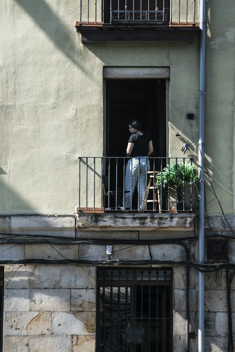 man in black suit standing on staircase