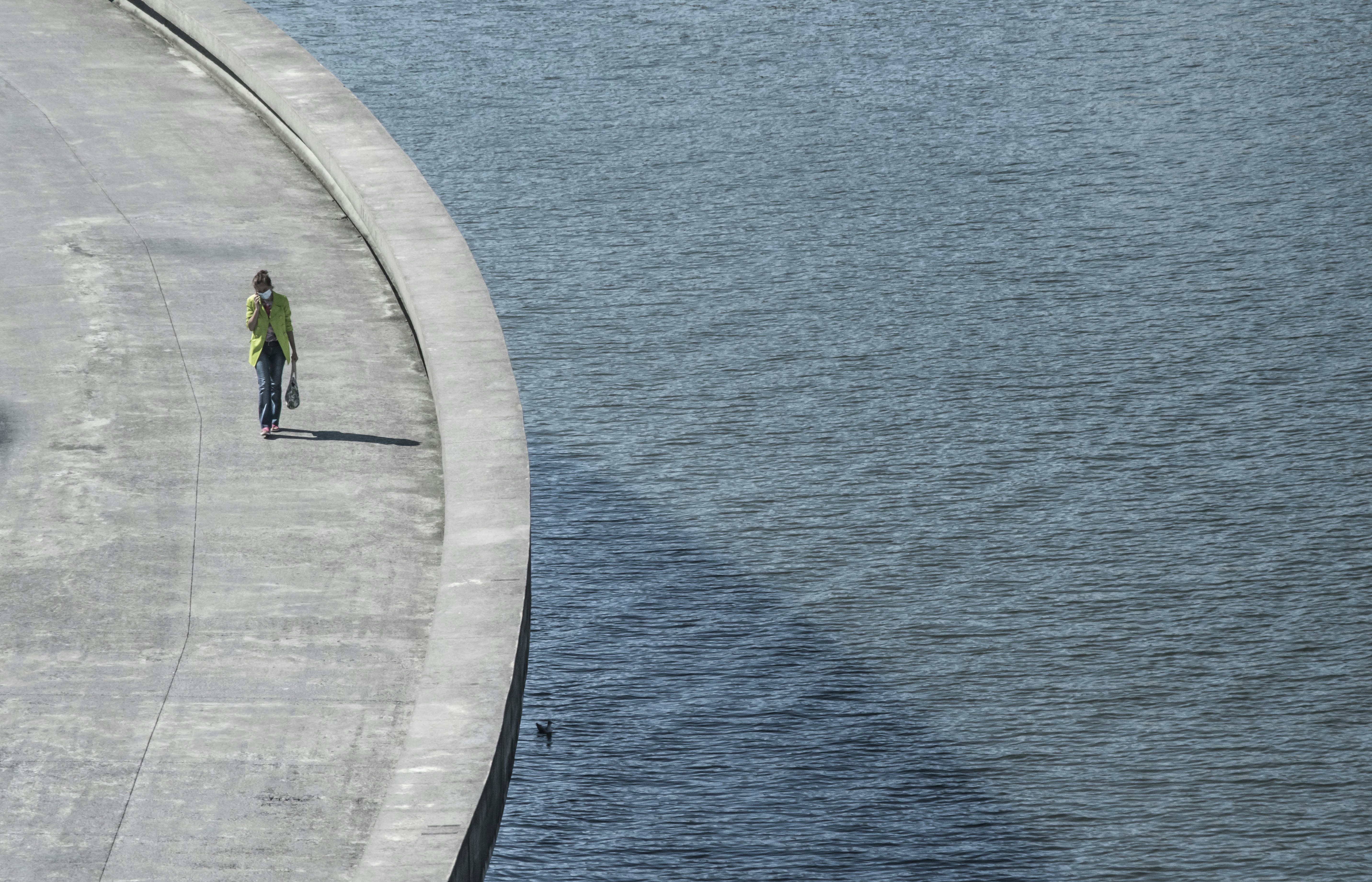 Woman walkingover a bridge in Bilbao.