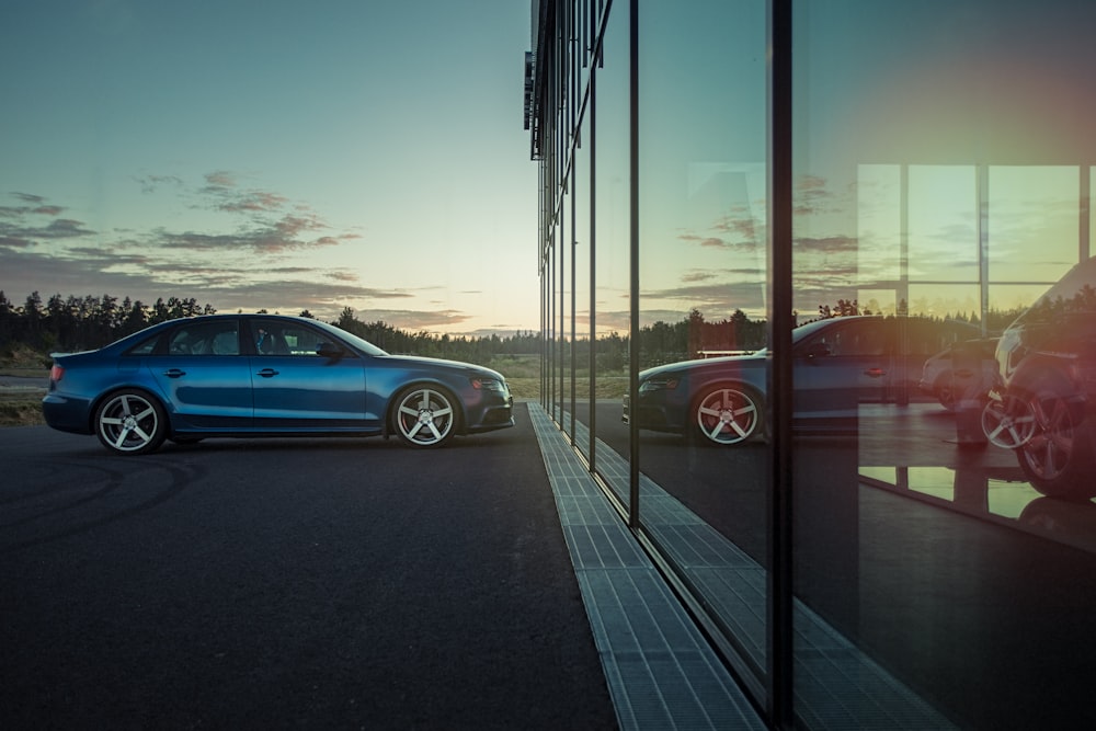 blue sedan on road during daytime