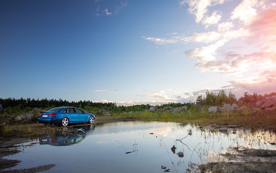 Blue car parked in nature near water