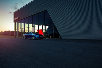 red car parked beside building