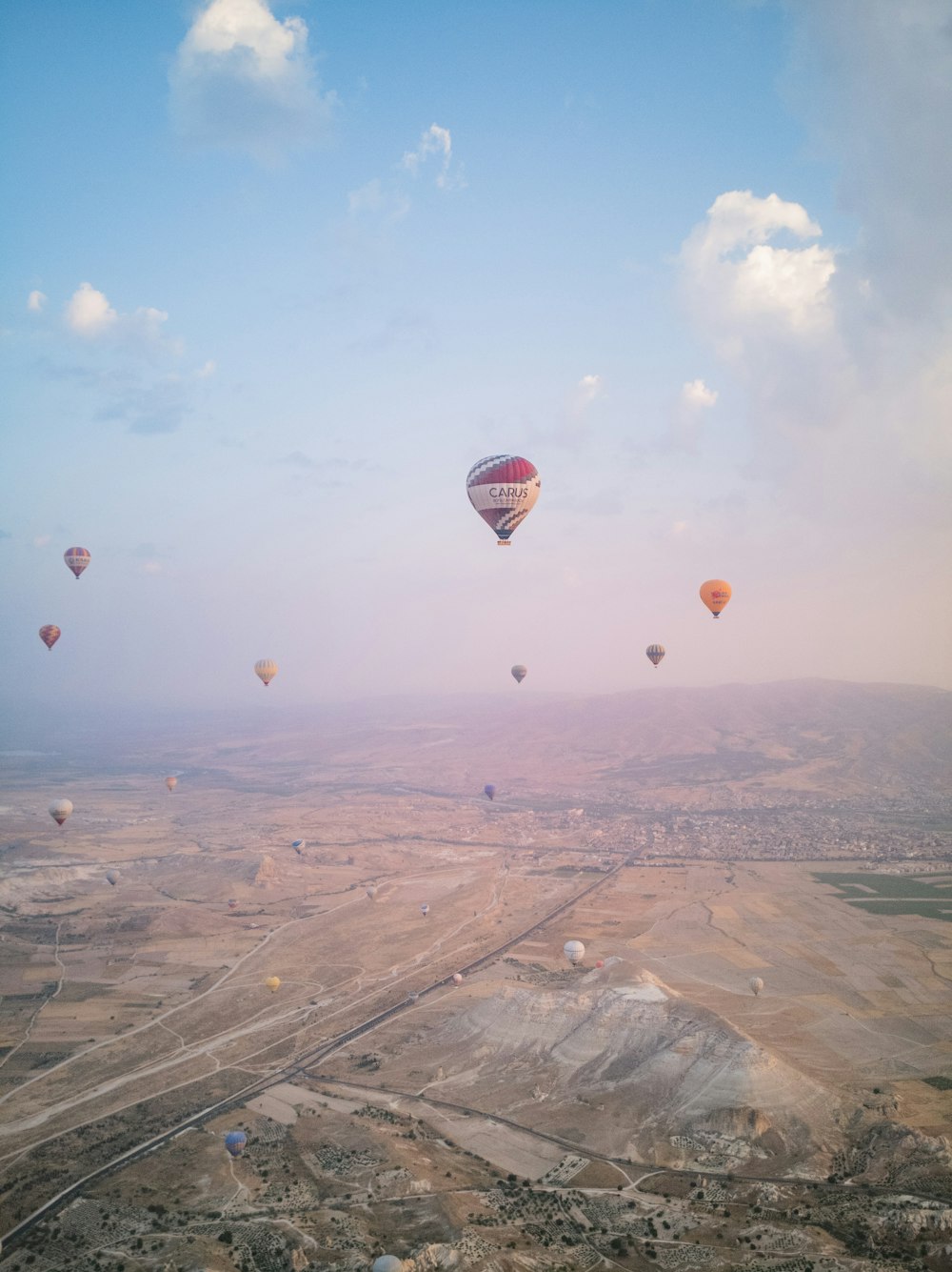 hot air balloons flying over the field during daytime