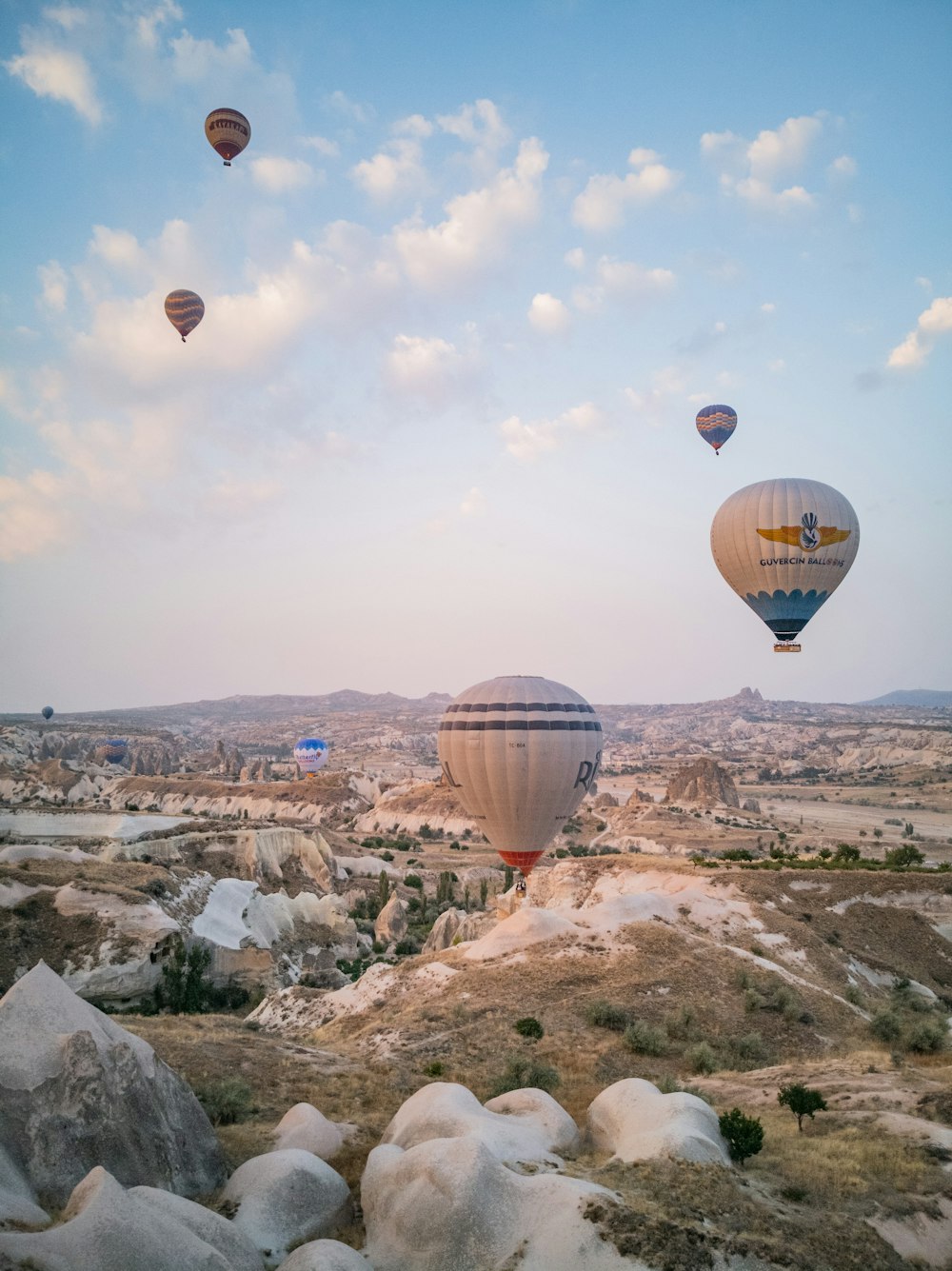 hot air balloons flying over city during daytime