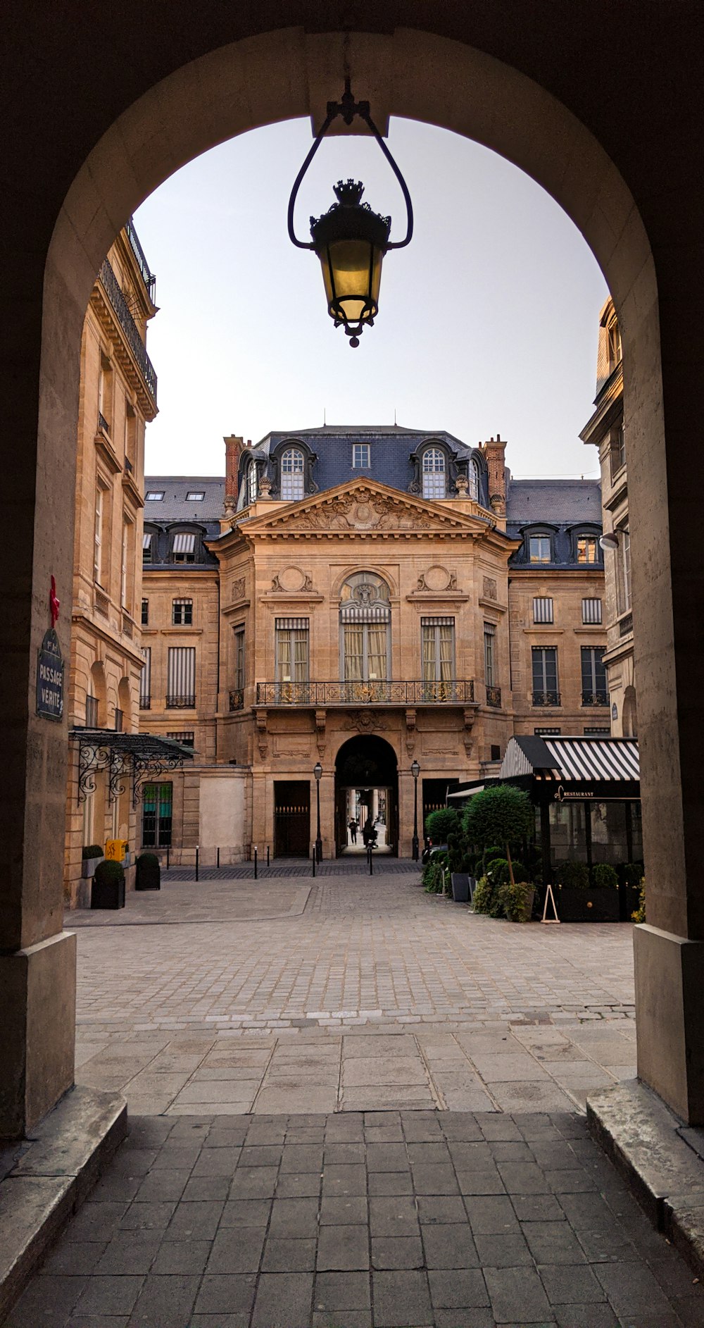 a large building with a light hanging over it's entrance