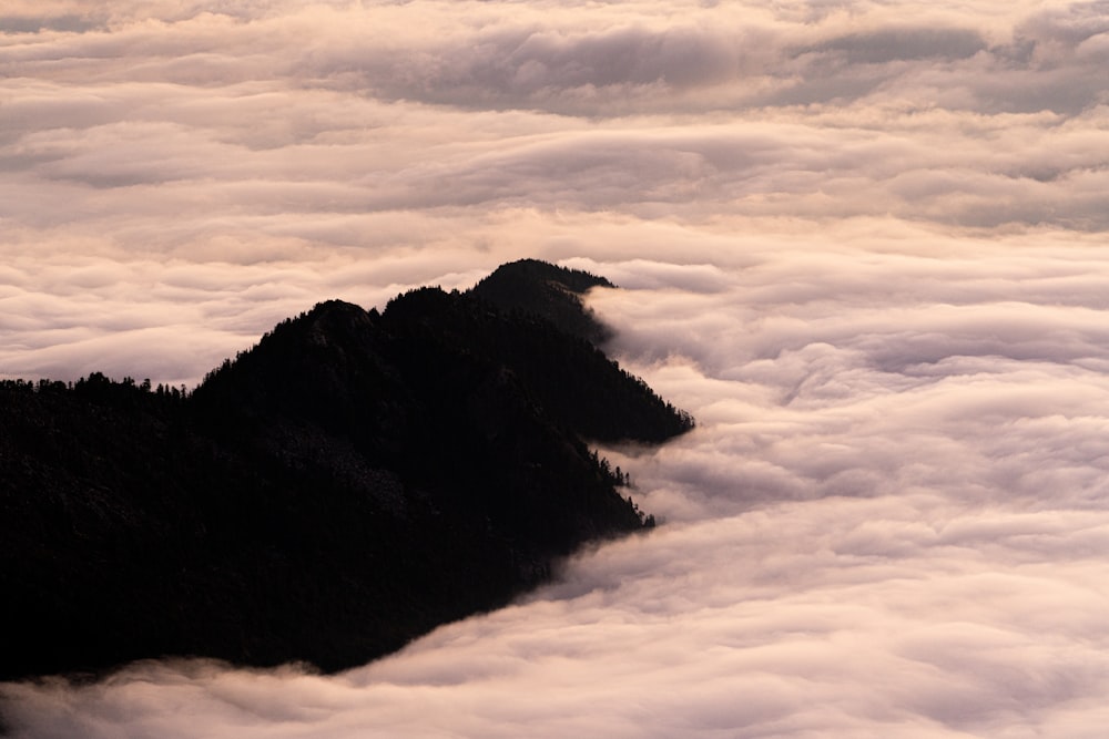 black mountain under white clouds during daytime