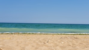 The beach just steps away from the hotel with gentle waves and golden sand