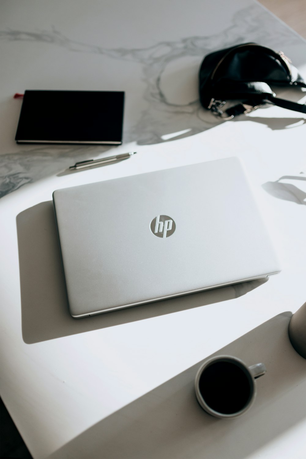 silver hp laptop computer on white table