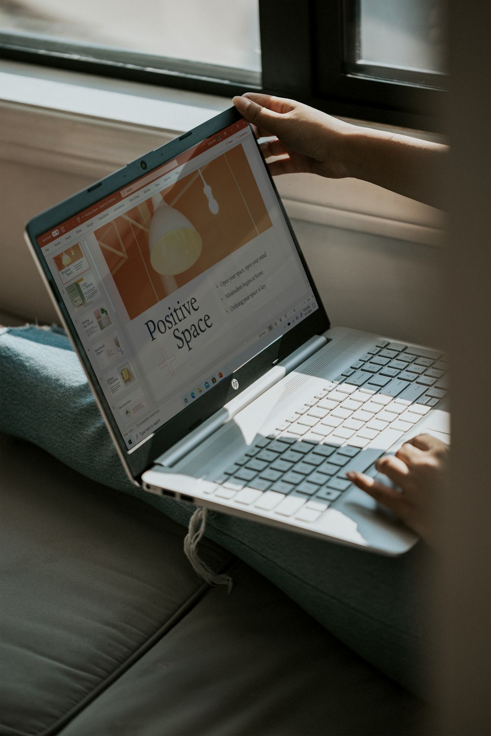 person using laptop on white table