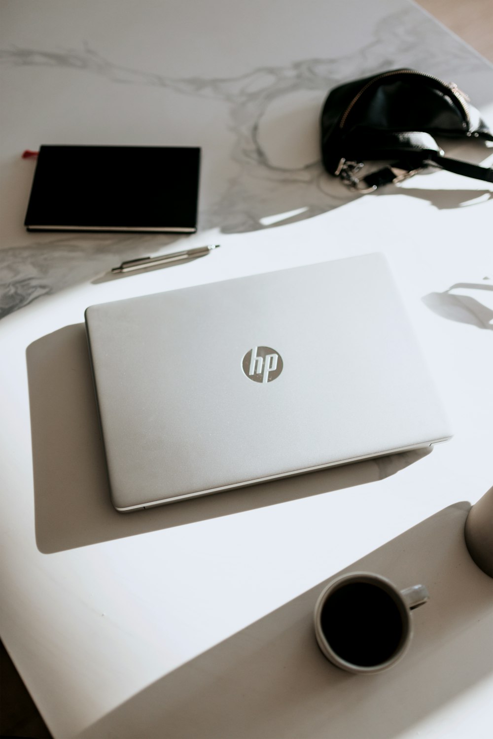 silver laptop on white table