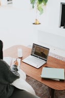 laptop on brown wooden table