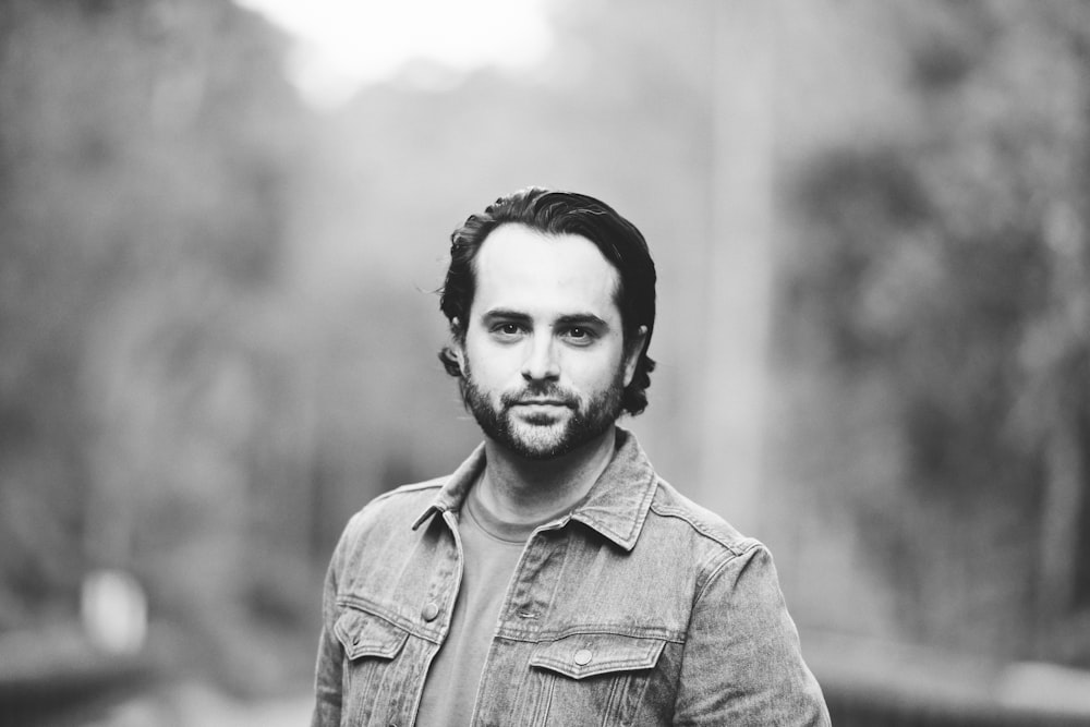 a black and white photo of a man with a beard