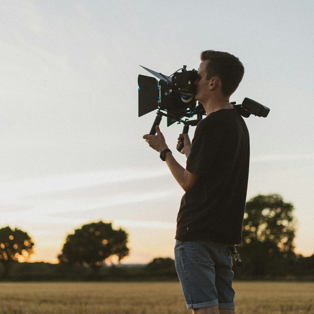 man in black shirt holding camera