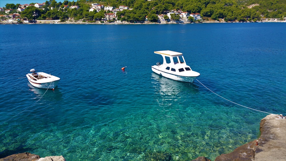 white boat on blue sea during daytime