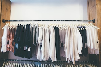 white long sleeve shirt hanging on black steel rack