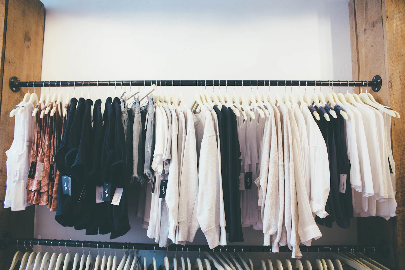 Neutral clothing collection displayed on a rack without people