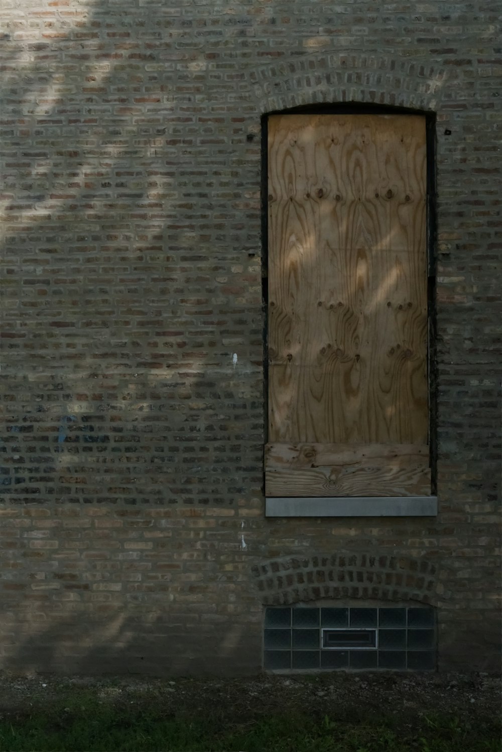 brown wooden door on brown brick wall