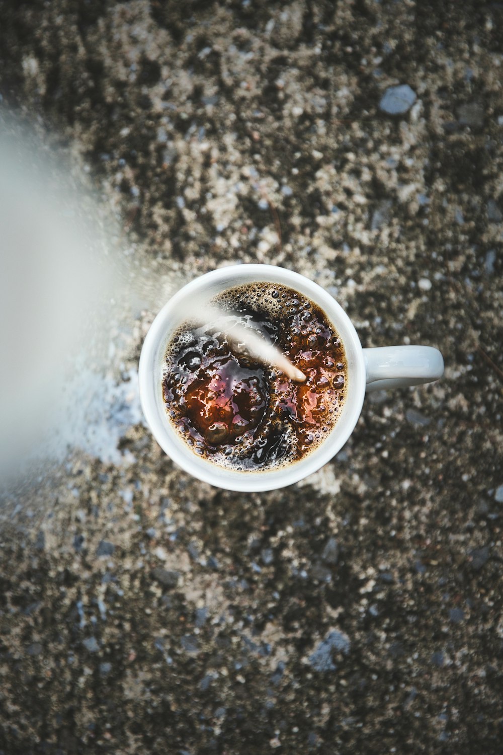 white ceramic mug with brown liquid