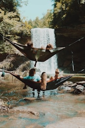 Family on hammocks in front of waterfalls