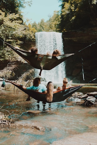 Guests relaxing in hammocks tied between trees, soaking in the peaceful natural surroundings.