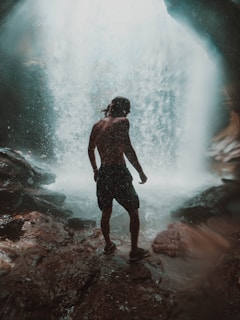 depiction of Kai Wordsmith standing at a waterfall