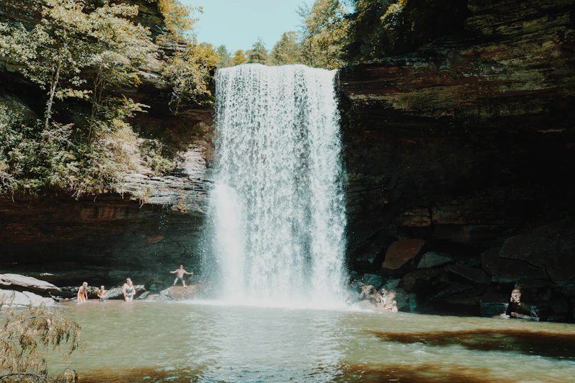 people sitting on water fountain during daytime