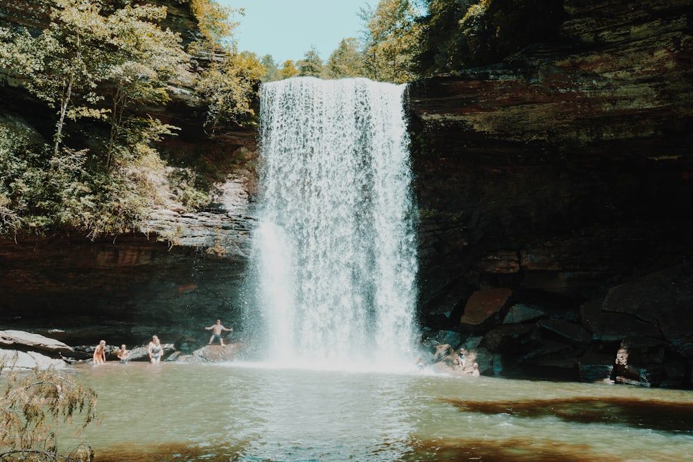 people sitting on water fountain during daytime