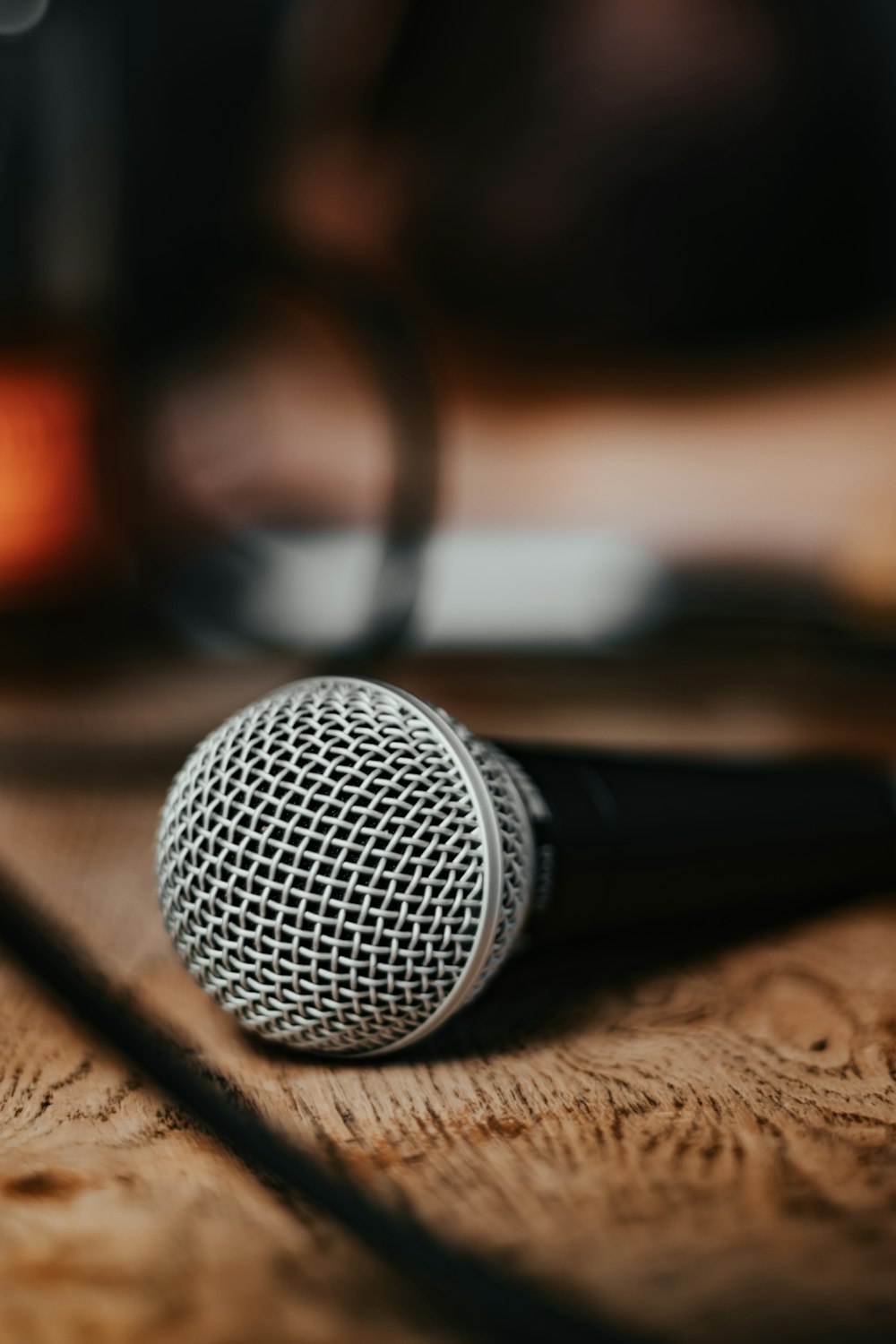 black microphone on brown wooden table