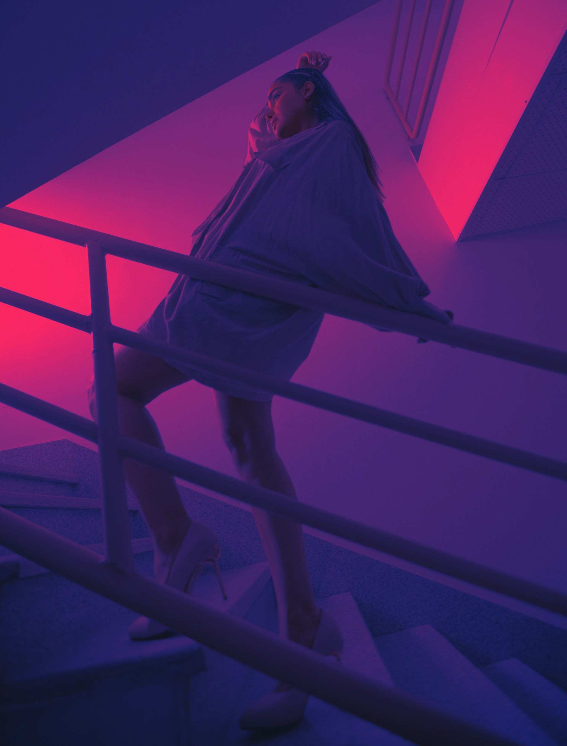 woman in white long sleeve shirt and black pants standing on stairs