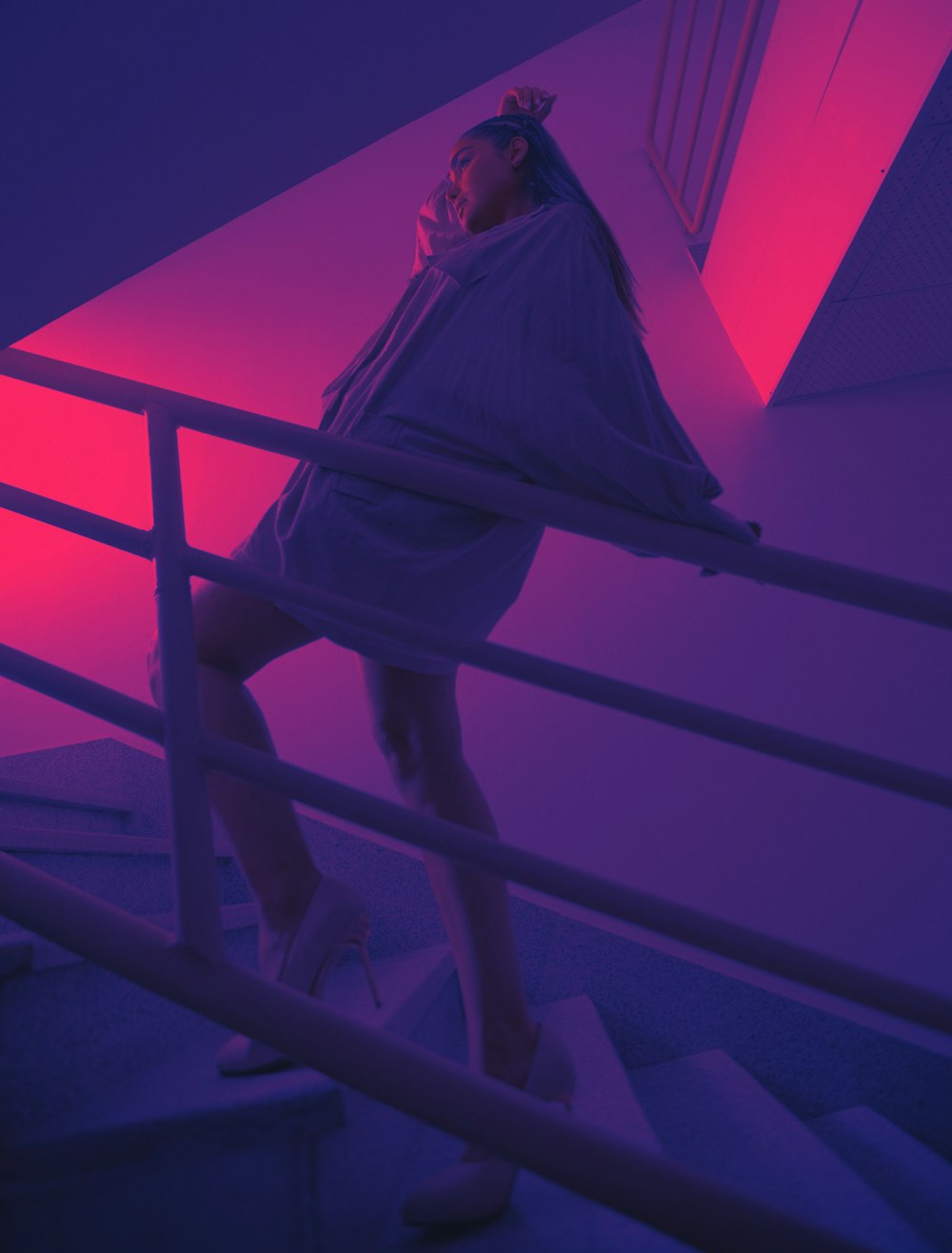 woman in white long sleeve shirt and black pants standing on stairs