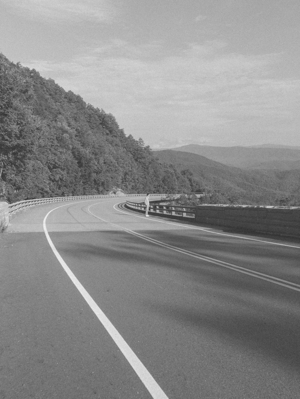 grayscale photo of road near mountain