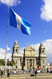 white and blue flag on pole