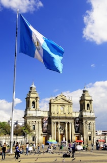 white and blue flag on pole