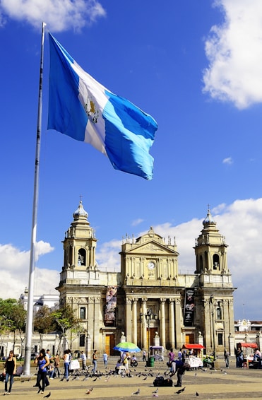 white and blue flag on pole