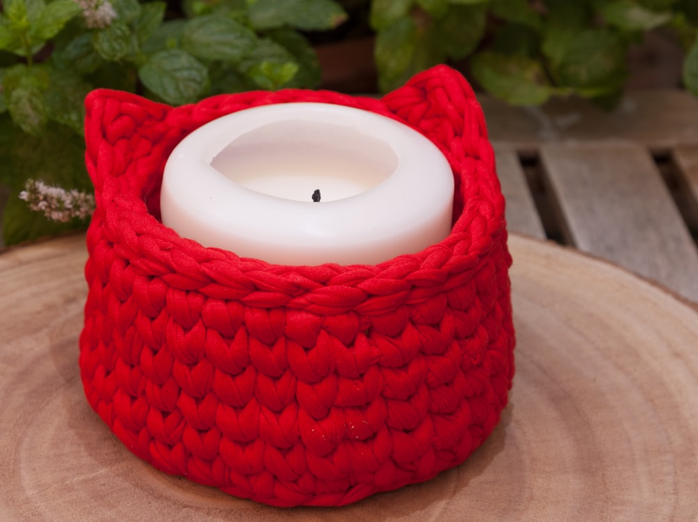 white candle on red round textile