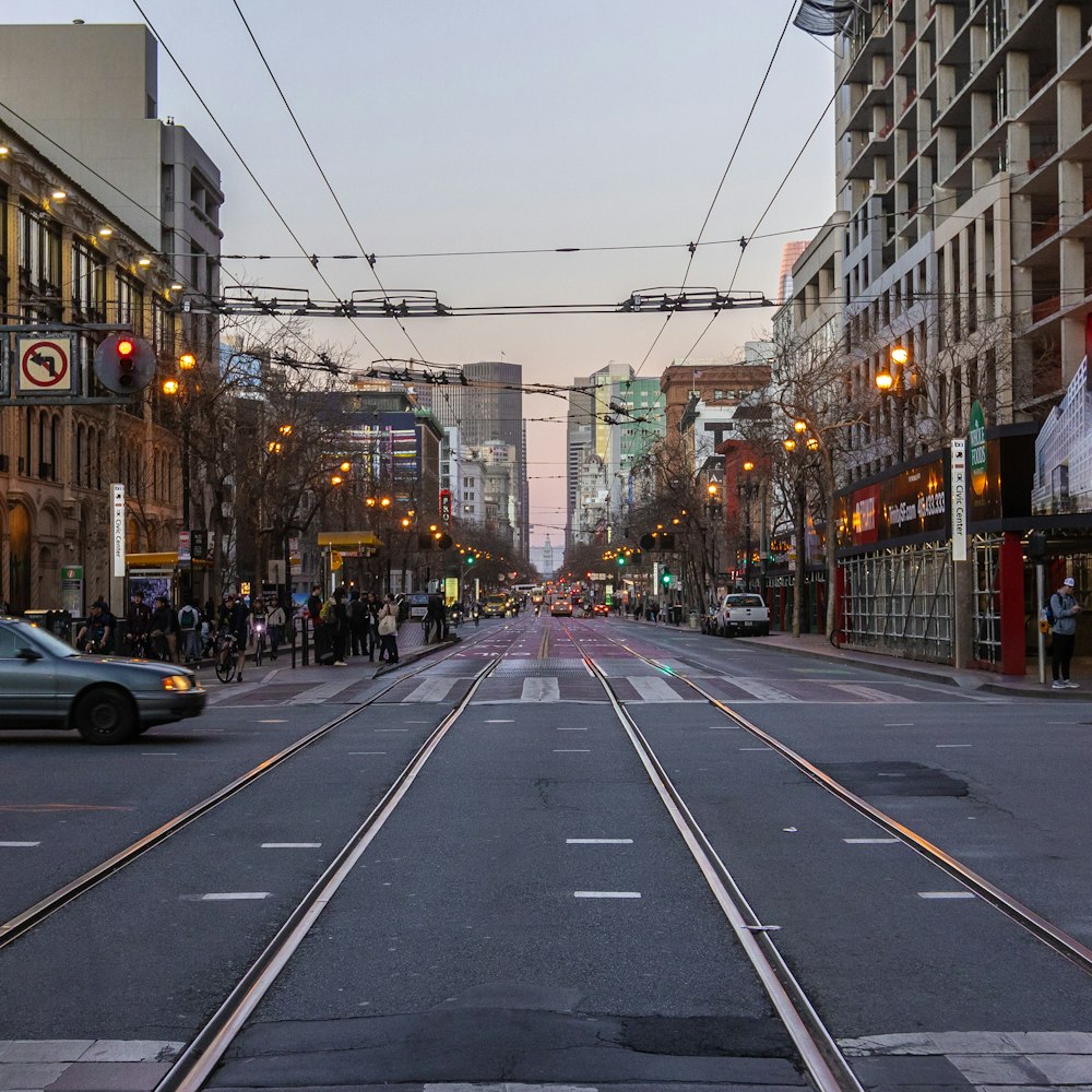 cars on road between buildings during daytime