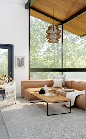 living room with brown sofa and glass window