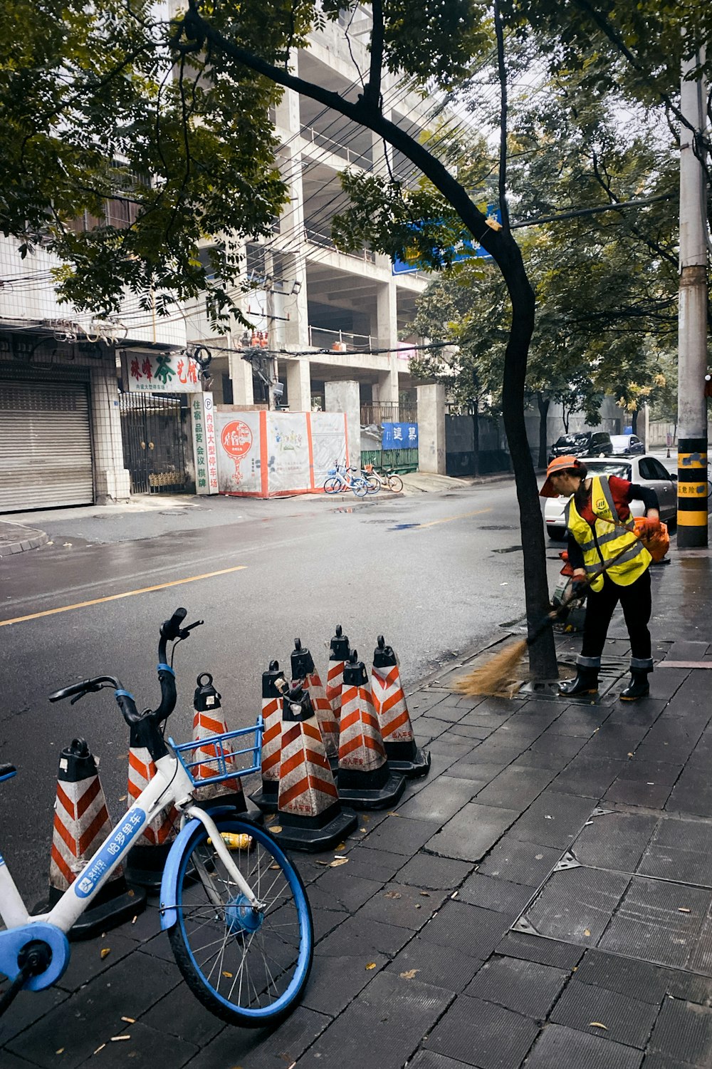 people in yellow shirt and black pants walking on sidewalk during daytime