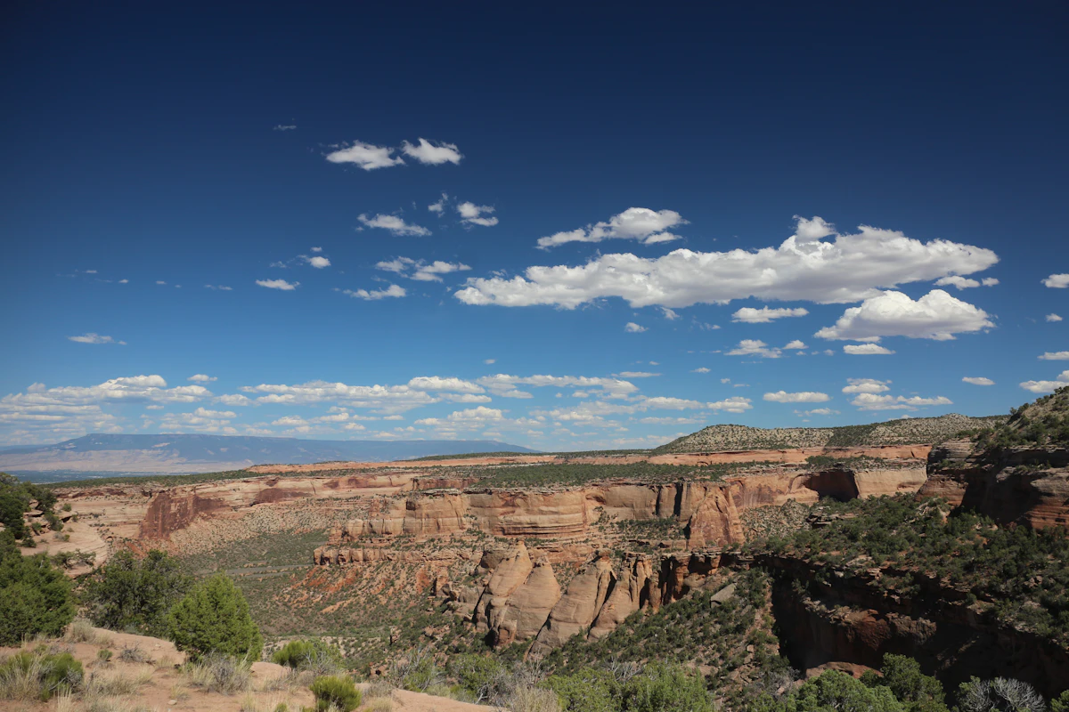 A wide sandstone canyon under a blue sky at Colorado National Monument, near Fruita