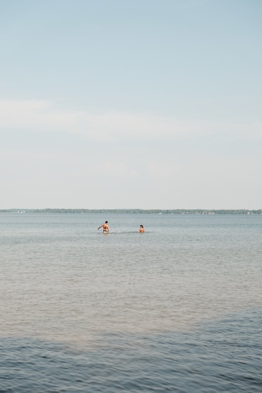 people in the beach during daytime in Sandbanks Provincial Park Canada