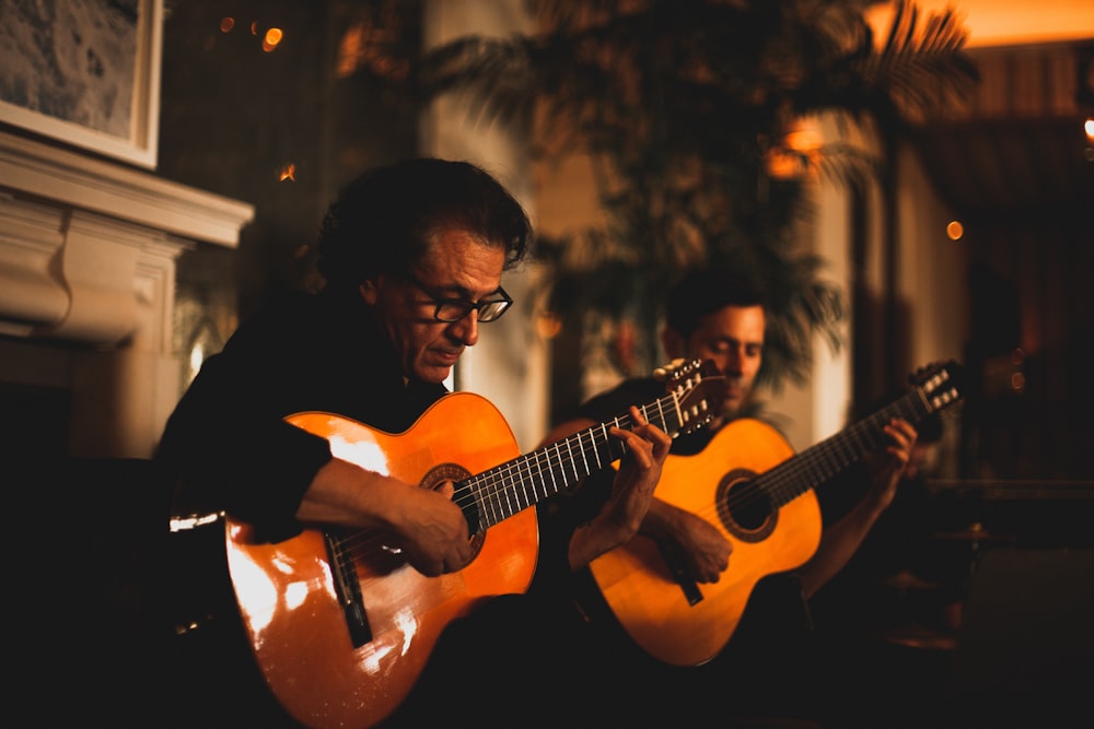man in black shirt playing guitar