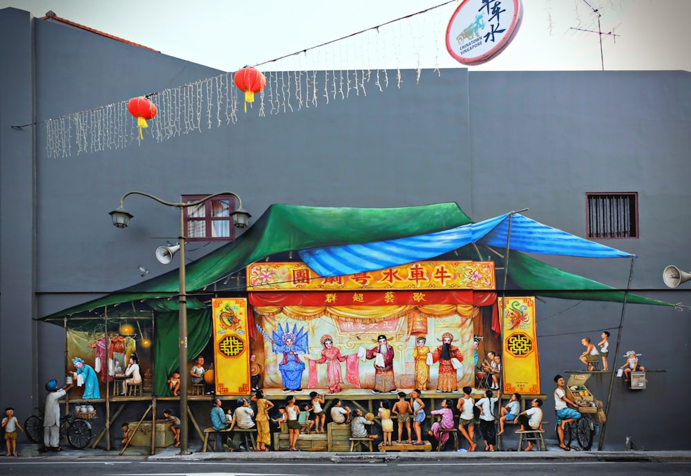 people standing near green and yellow canopy tent during daytime