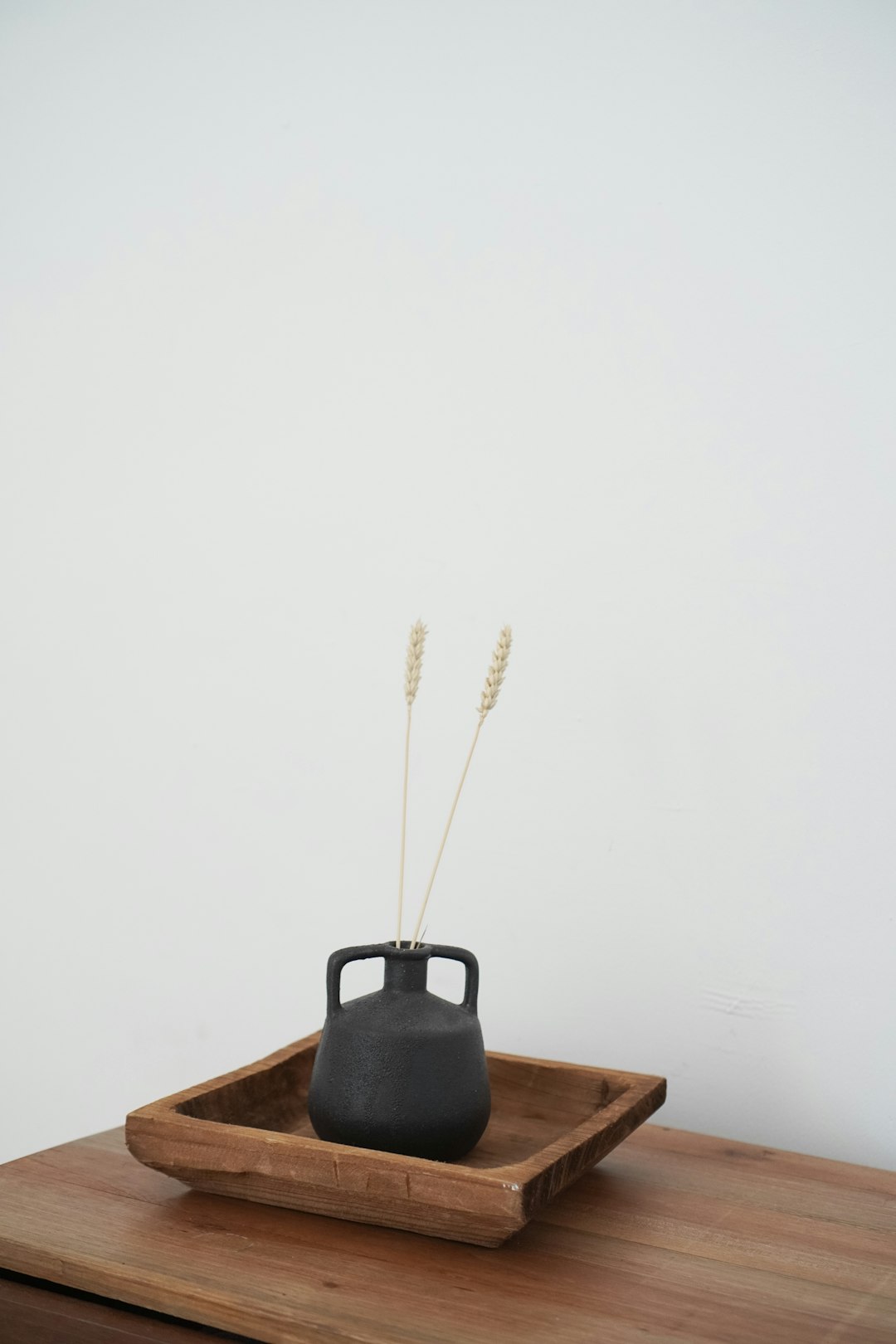 black leather bag on brown wooden table