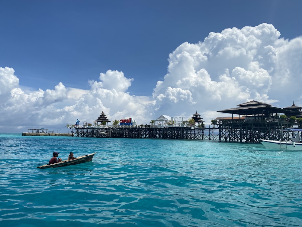 people on boat on sea under blue sky during daytime