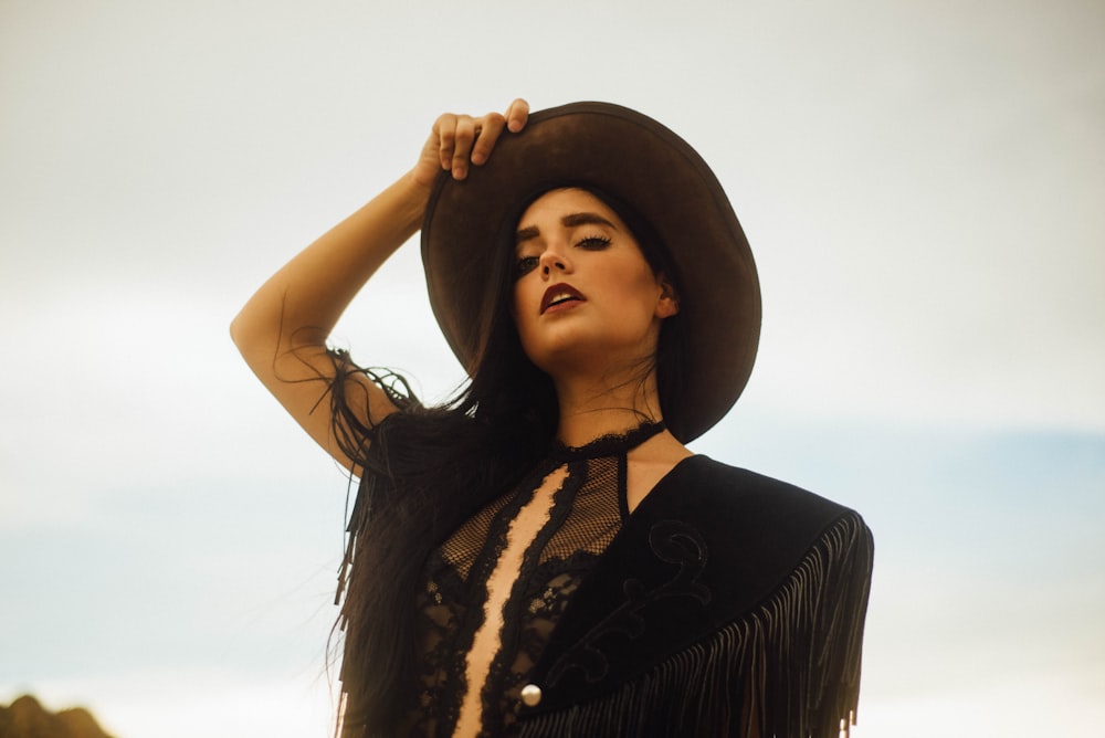 woman in black and white floral dress wearing black hat