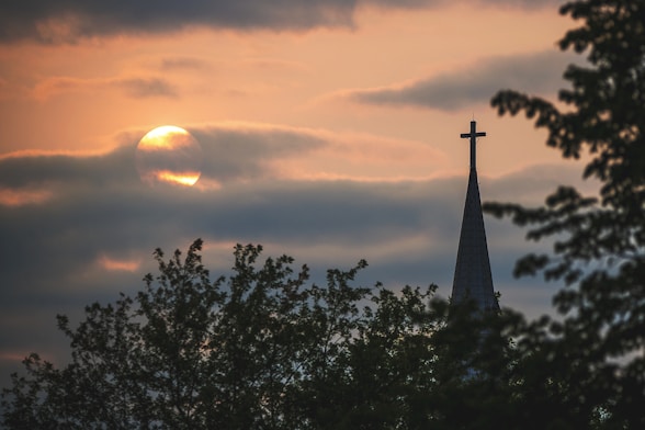 silhouette of cross during sunset