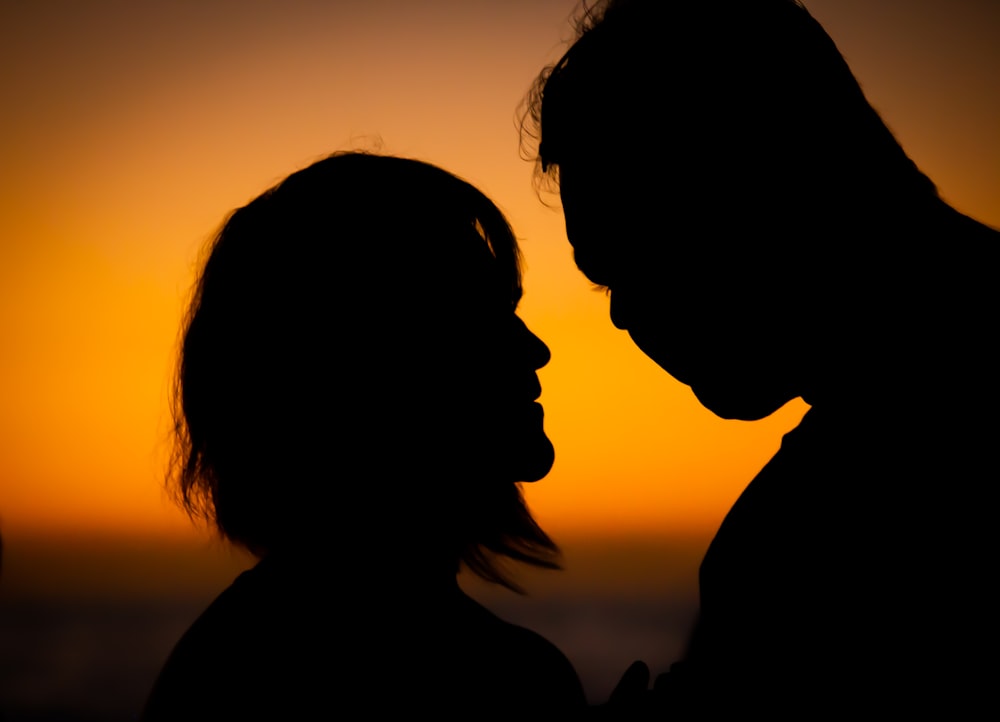 silhouette of 2 person during sunset