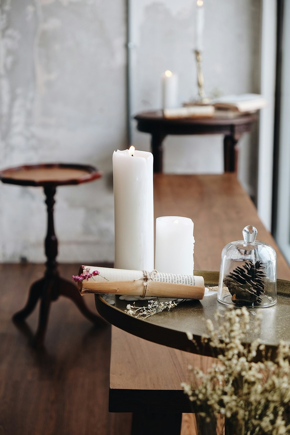 white pillar candles on black metal candle holder