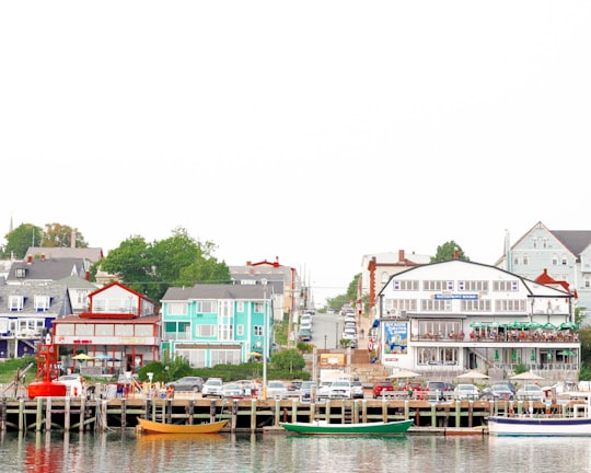 boat on dock near houses during daytime in Lunenburg Canada