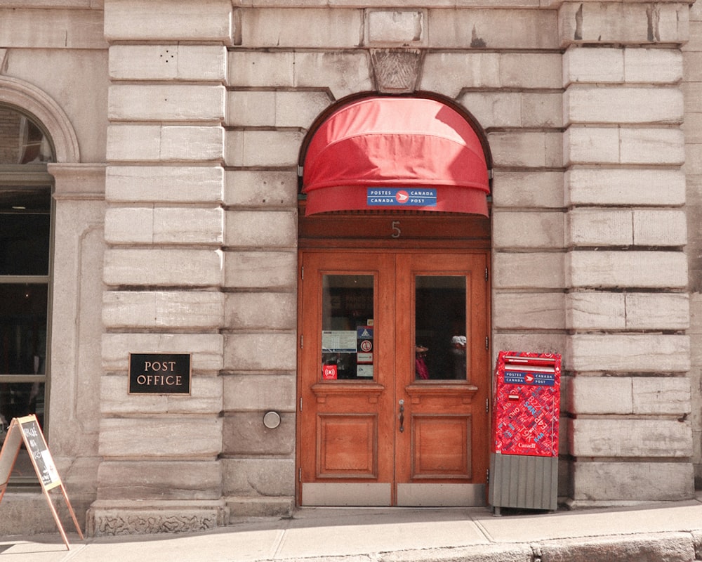 red telephone booth on brown brick wall